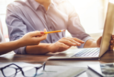 two business workers looking at a laptop