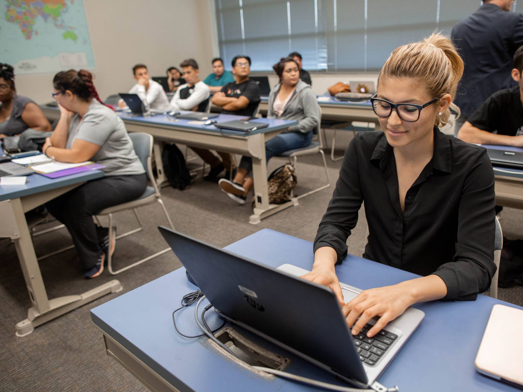 overhead view of a desk with two hands pointing at a sales chart