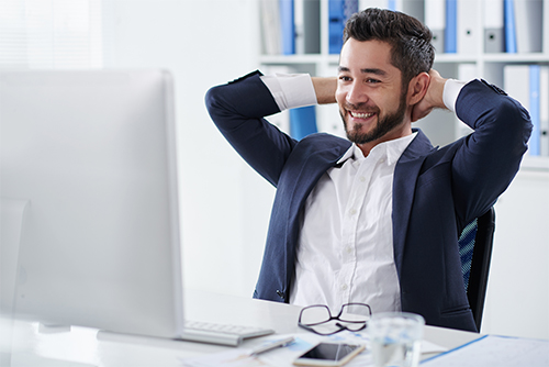 Office worker finishing work on computer