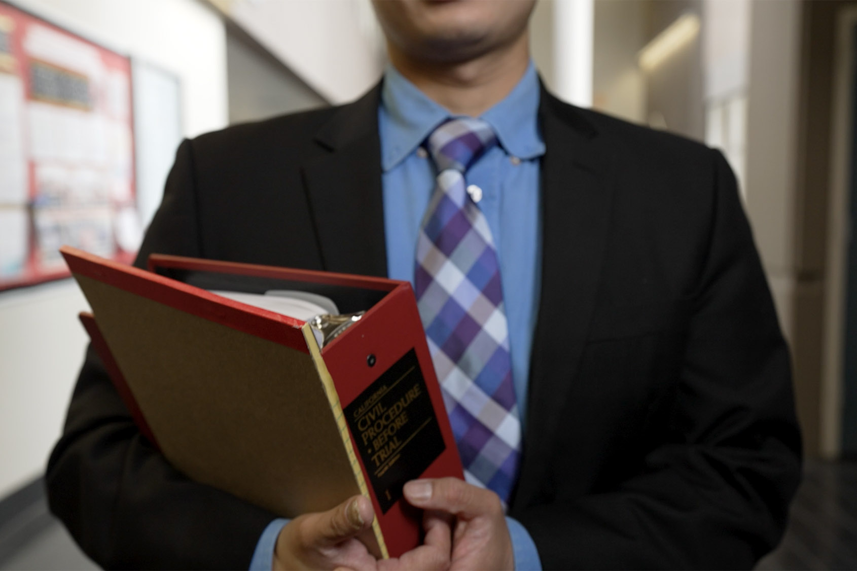 paralegal bachelor program student holding a binder