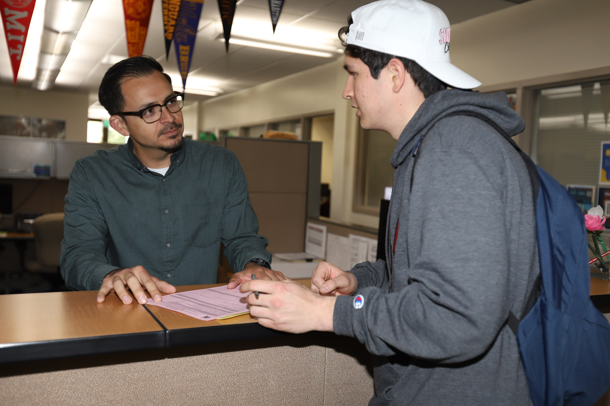 Counselor assisting a male student