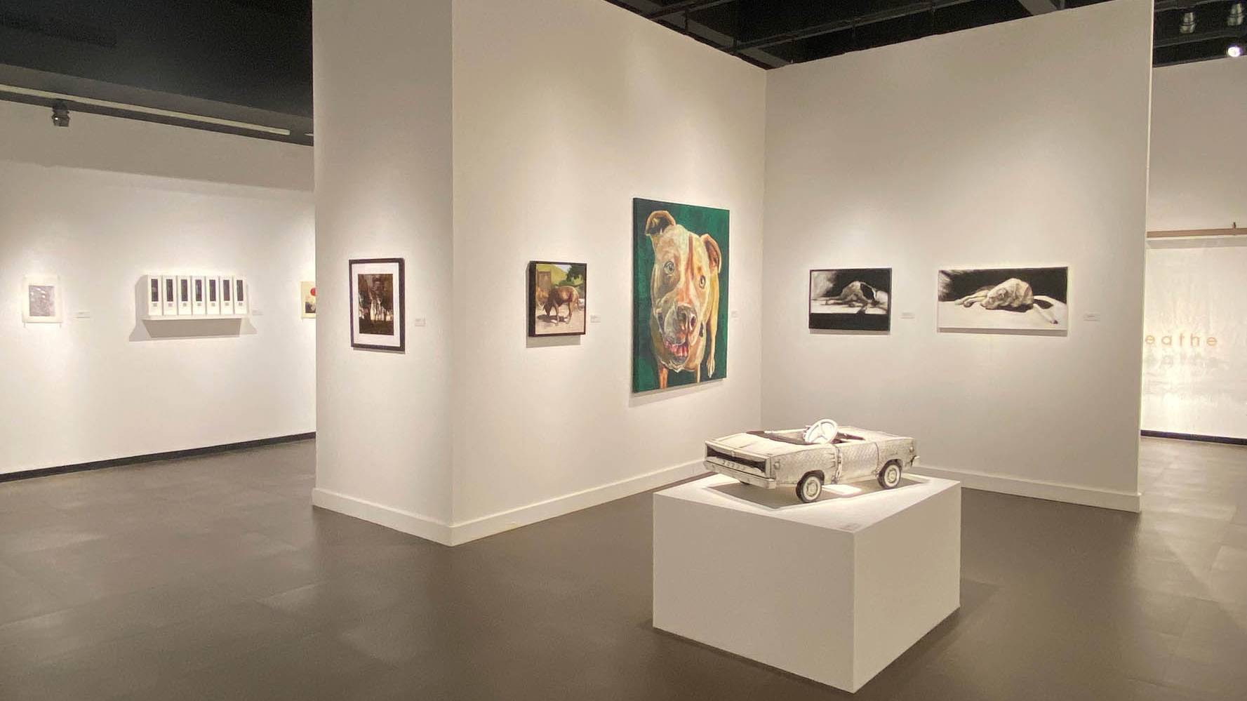 art gallery with model car in center