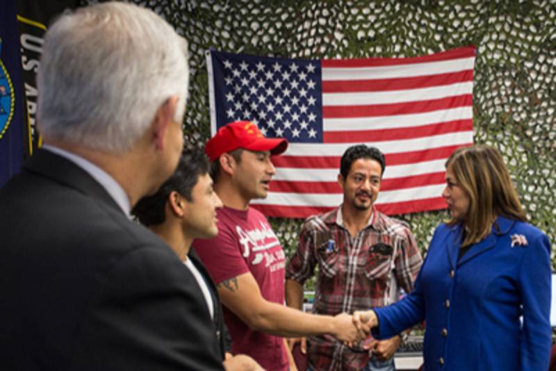 hispanic male shaking hands with political candidate