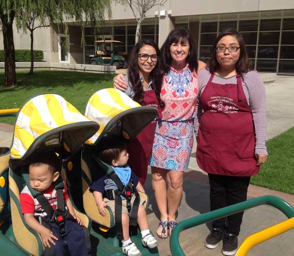 two CDES students and an instructor with toddlers
