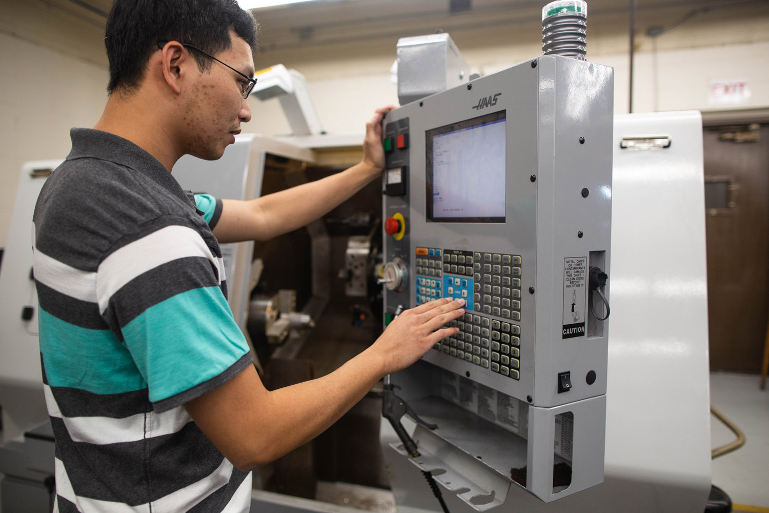 Male student working on machine