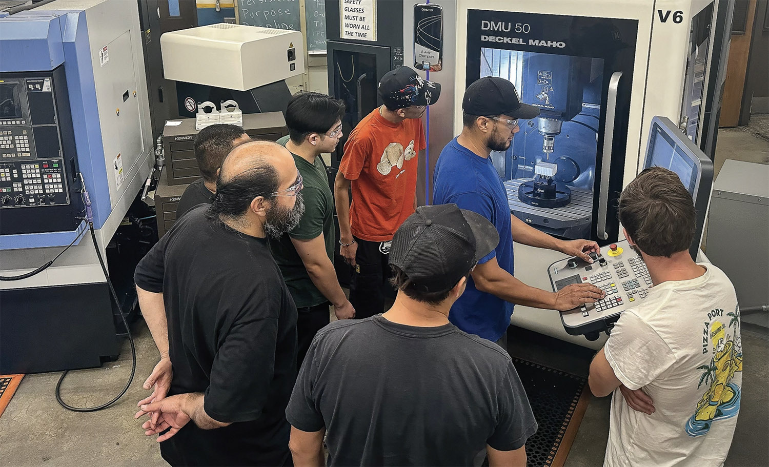 students gathering around a DMU50 machine