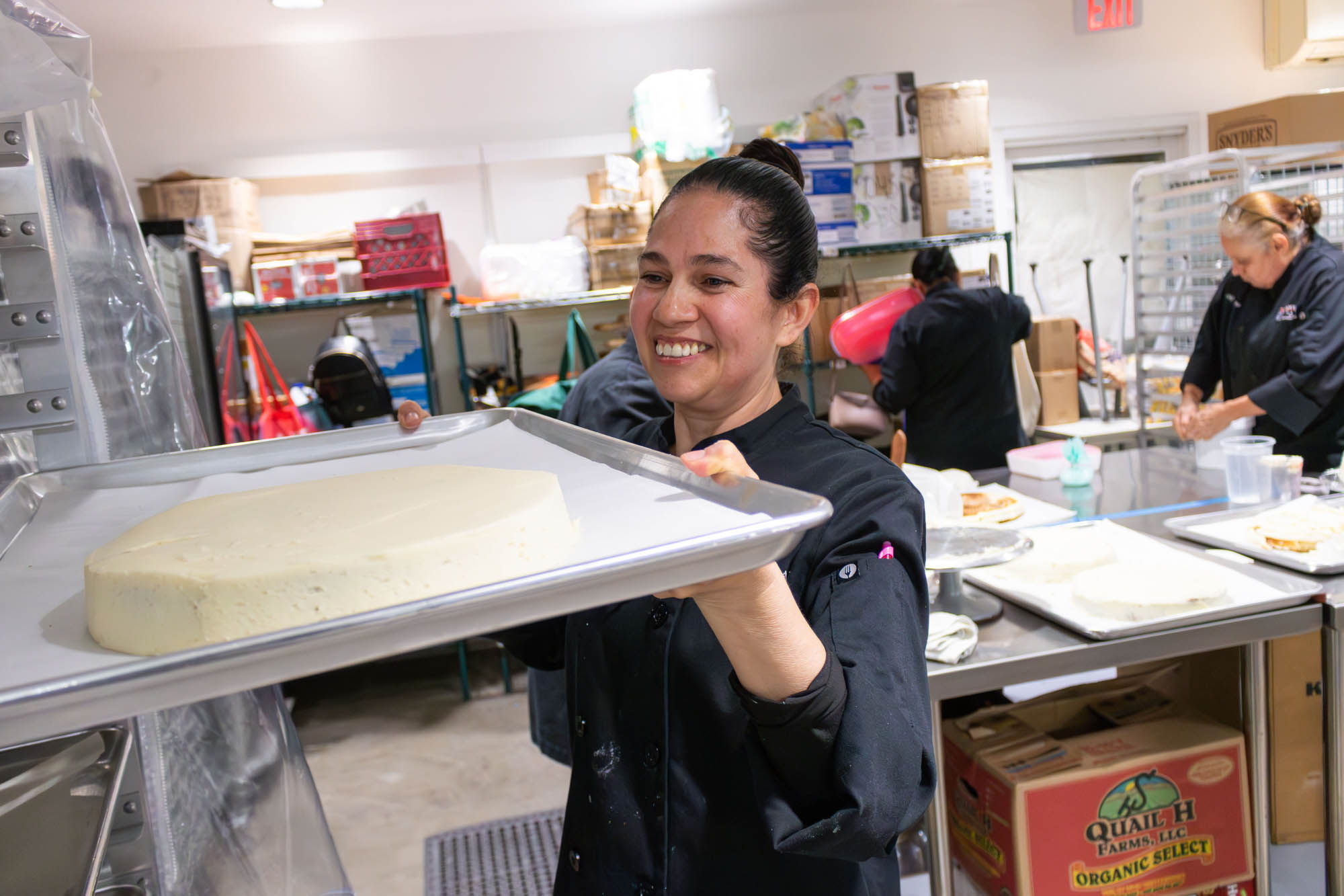 Female Culinary Arts student setting cake onto a tray