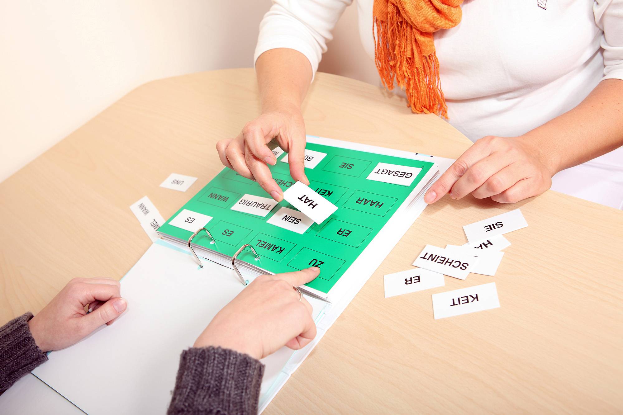 people working with a language booklet