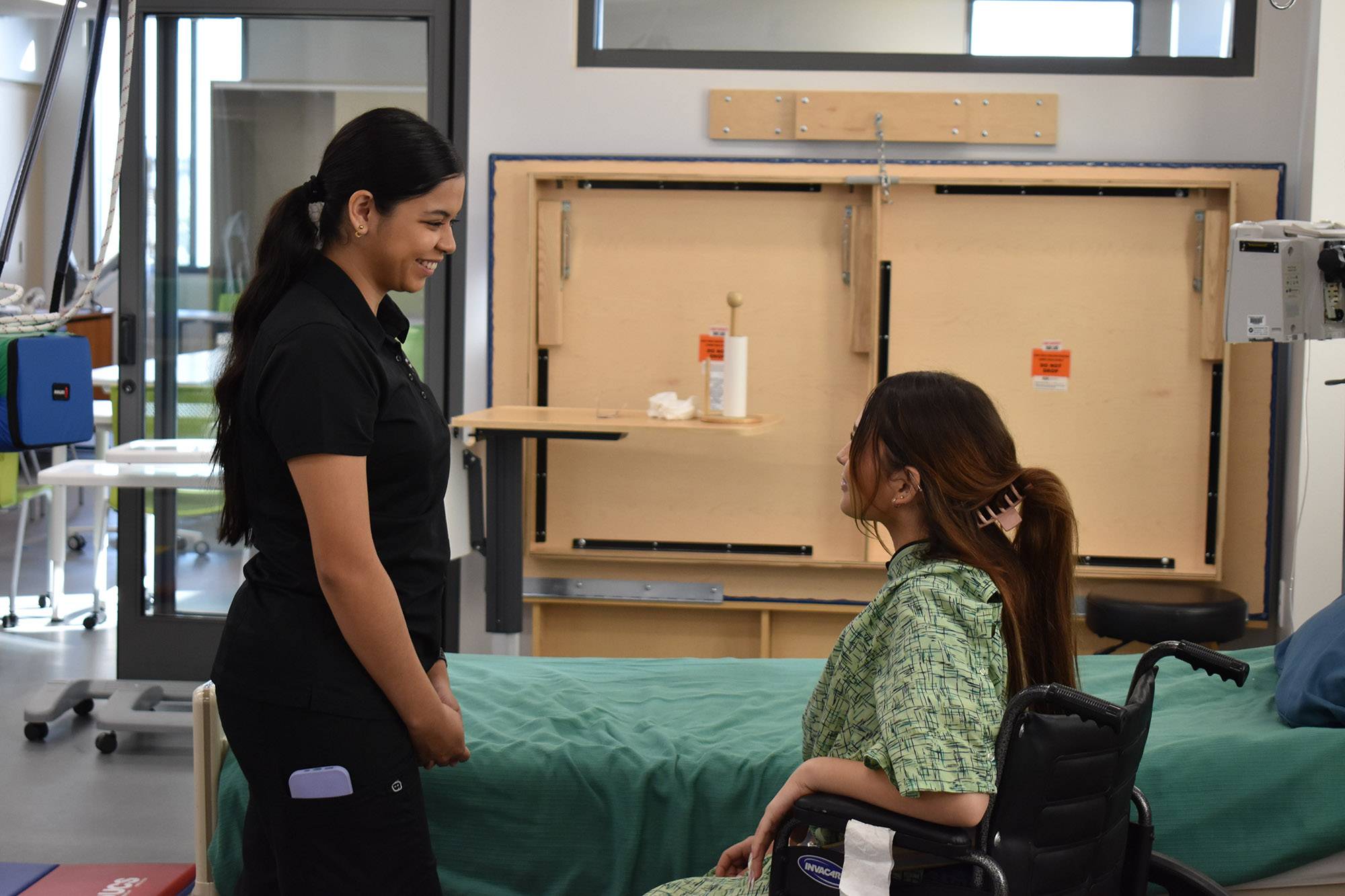 Female OTA student practicing skills with classmate