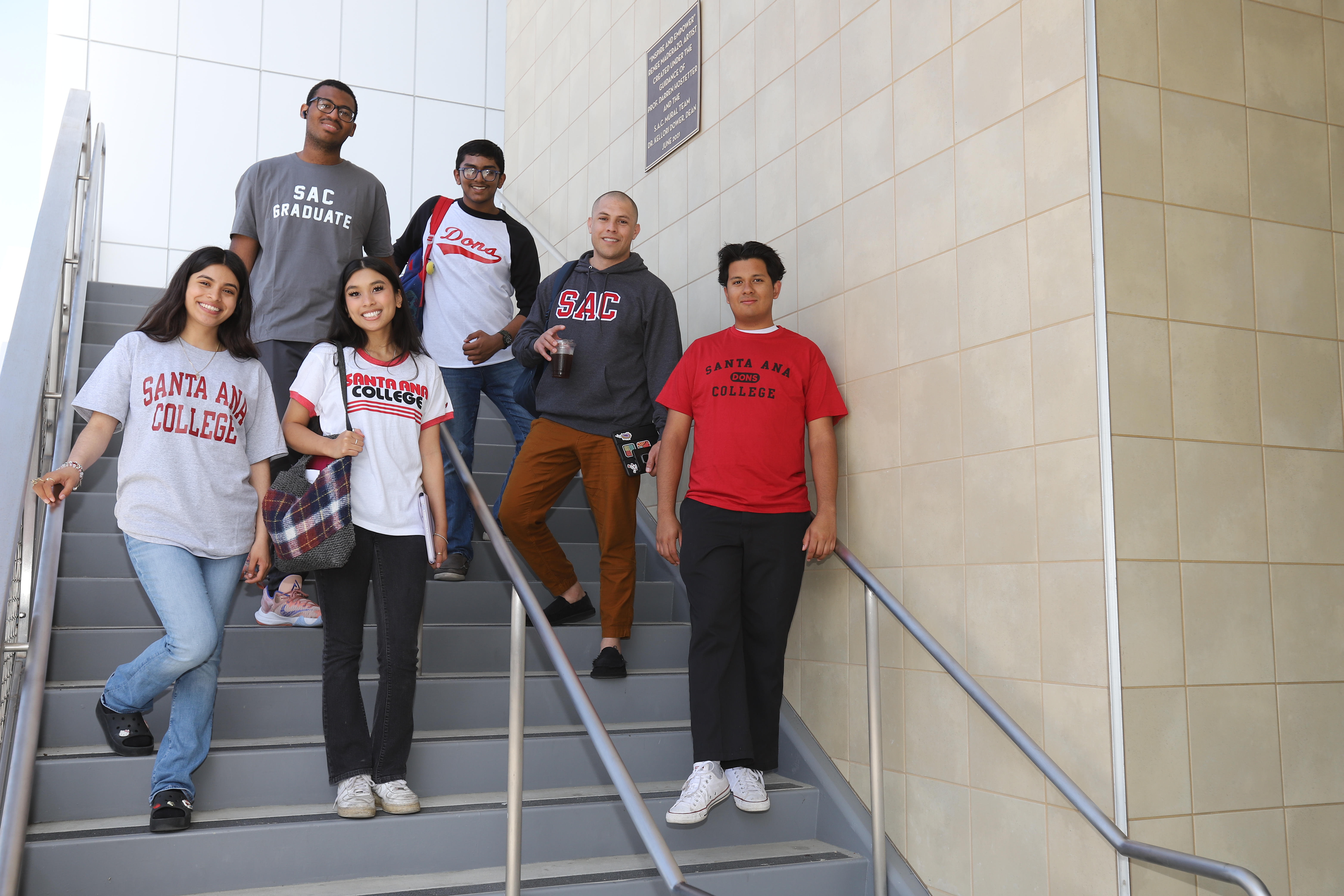 Diverse group of male and female students standing on the staircase at the Johnson Student Center