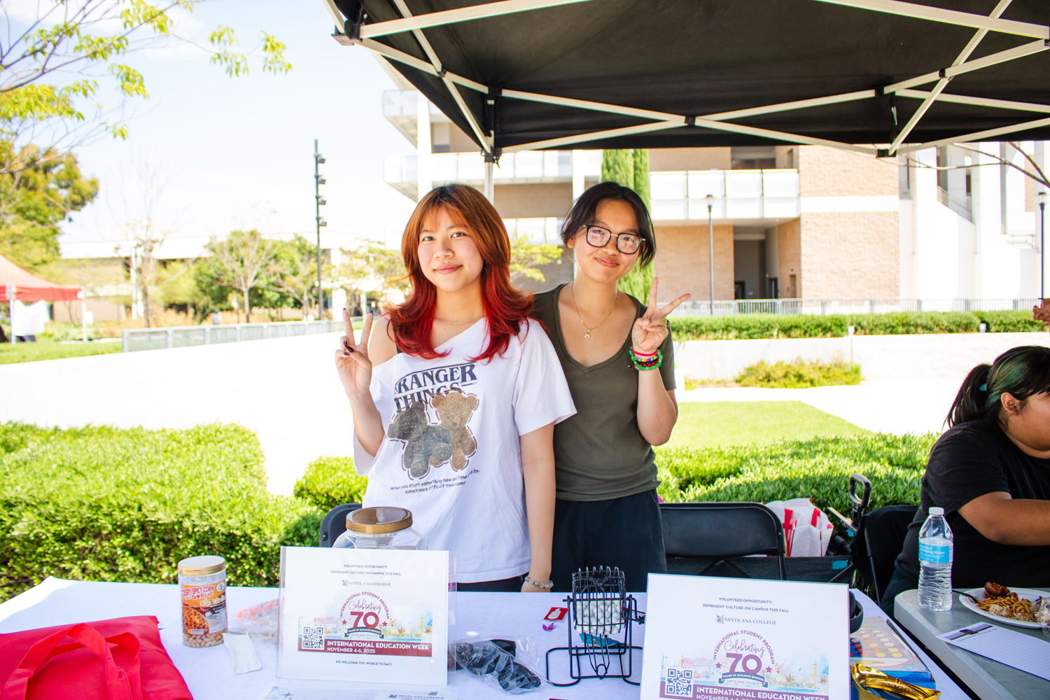 Two International student club members posing at booth