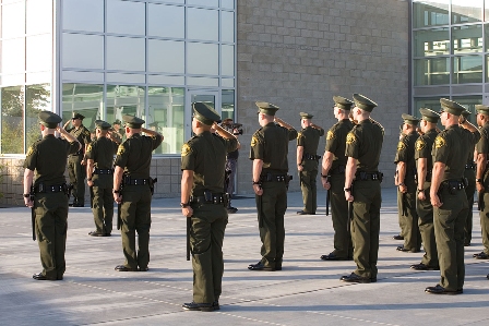 Santa Ana College Criminal Justice Academy students salute by their building