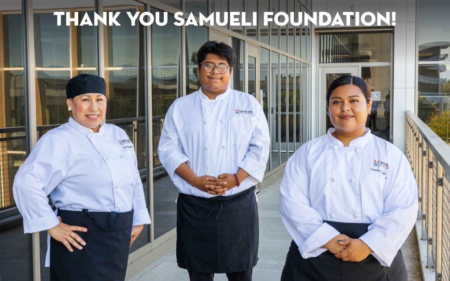 Culinary Arts students smiling at the second floor of Johnson Student center with a "Thank you Samueli Foundation" message above them
