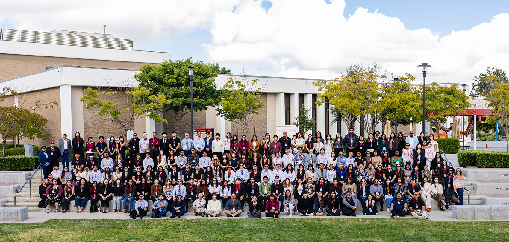 Scholarship students line up at amphitheater for a giant group photo